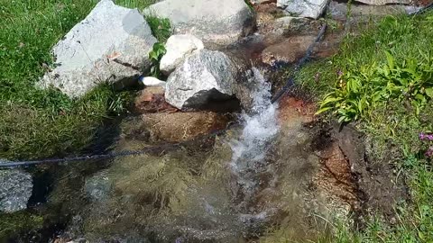 water fall beneath lakes in a mountain