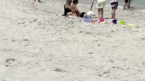 Grils chill on the beach