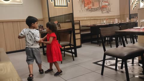 Energetic Kids' Dance Performance at a Vibrant Restaurant