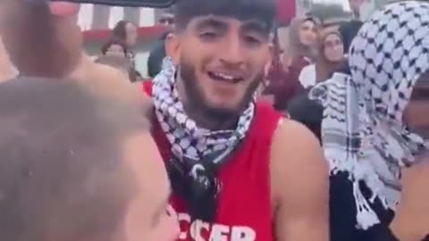 Palestine supporter taunts an Israel supporter with a video of hostages captured by Hamas