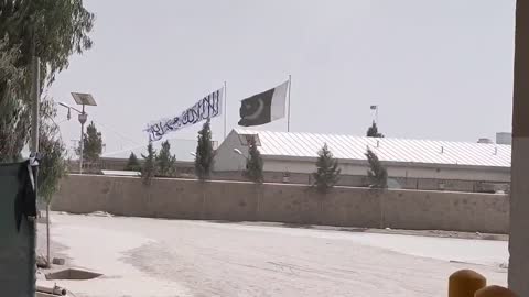 Taliban Flag with Pakistani flag at Spin Boldak Afghan-Pakistan border