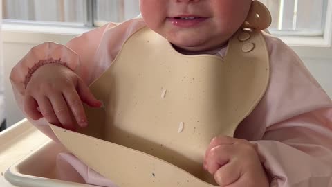 Baby Tries to Take Her Bib Off