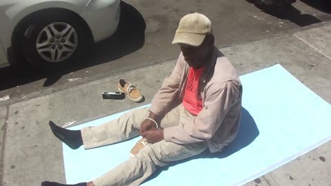Luodong Massages Black Man In Tan Clothes On Street