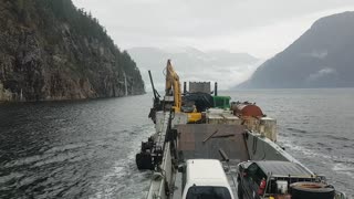 Inlet Raider and barge loading and delivering equipment on the BC coast.