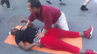 Luodong Briefly Massages Black Man In Red Pants On Sidewalk