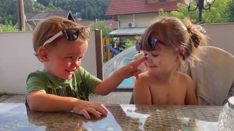 Sweet boy showers little girl with kisses