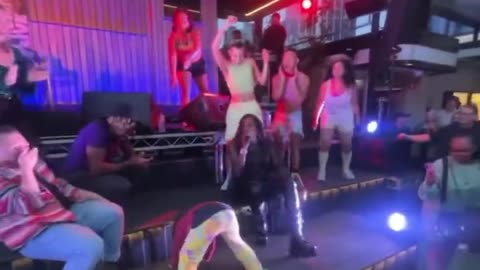 Child twerks in front of audience at Melbourne's Rooftop Bar.