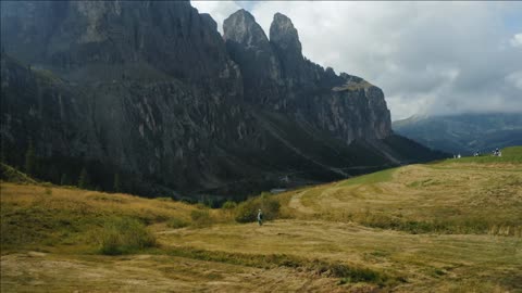 women hike walk near passo gardena in the dolomites italian alps