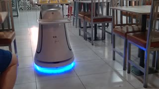 A Robot Waitress Delivers The Food