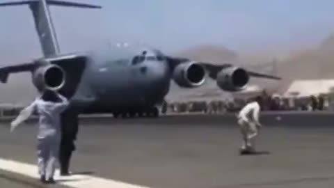 Afghan Civilians on Wheelhub of Departing Air Force Plane During Kabul Evacuation Aug. 16, 2021