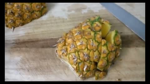 Cutting pineapples into bite-sized