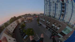 Base Jumpers Flip From Roof Top During an Early Sunrise