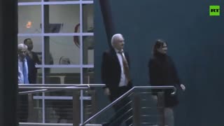 Assange embraces his wife and father to thunderous applause in Canberra