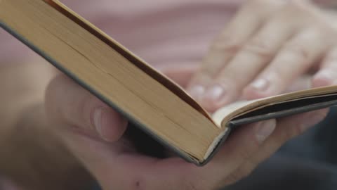 Person flipping through a book looking for a page