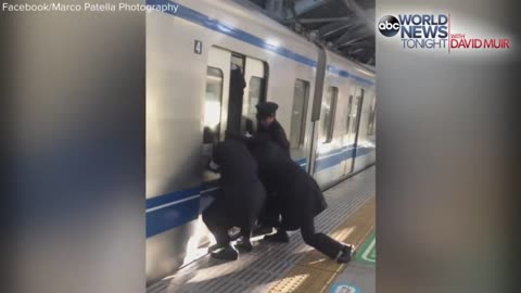 Professional Pushers Shove Passengers Onto Busy Tokyo Train