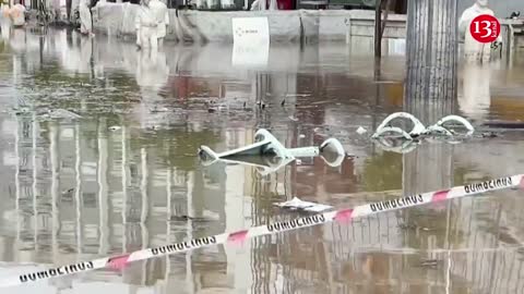 In Lisbon, torrential rain floods streets and sweeps away cars.