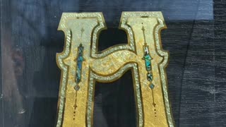 The letter H reverse glass gilding.