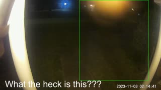 Mysterious light at door picked up by security cam at 2:14 AM.
