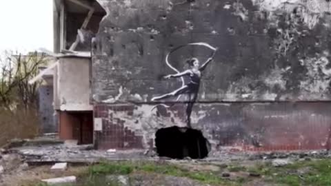 street artist with his works on the walls of houses in Ukraine.