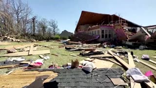 Grandmother walks through debris of home hit by tornado