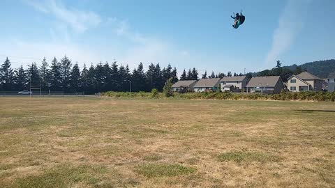 Paraglider Landing in Open field during Softball Tournament