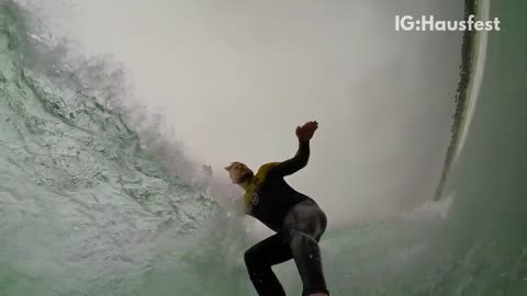 Wetsuit go pro surfer guy hit by wave barrel in slow motion