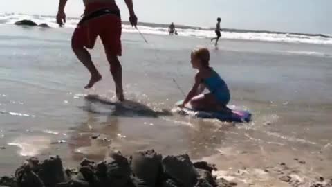 Collab copyright protection - shirtless dad pulls daughter beach