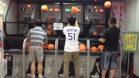 Man Shoots Hoops At The Arcade With Both Hands