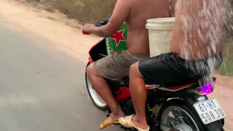 Dudes Shower While Driving a Scooter