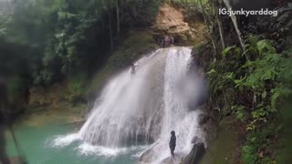 People on waterfall cliff failed back flip