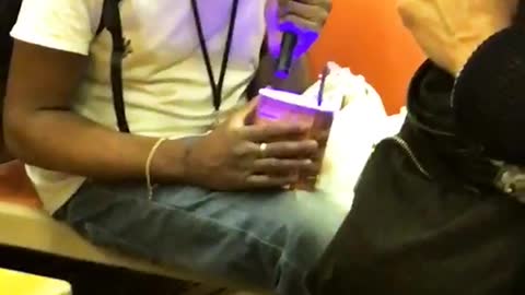 Man flashes purple light into ice cream container