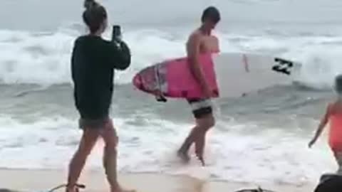 Guy walks into ocean with board just to get picture taken