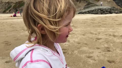 Funny Little Girl Flies a Kite for the First Time