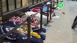 dozens of migrants sleeping on cardboard outside the iconic Roosevelt Hotel in Midtown Manhattan