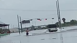 Water skiing down flooded street from Tropical Storm Imelda