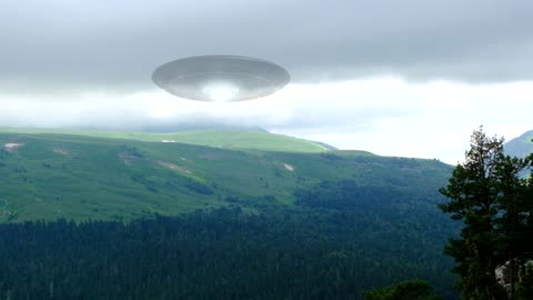 A huge UFO hovers over the mountains