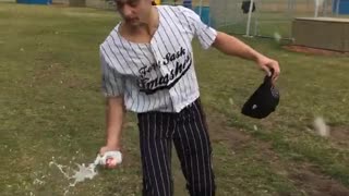 Guy in baseball uniform cracks beer over head