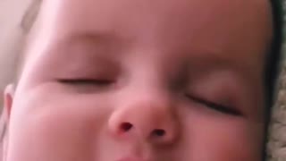 Cute baby calling his mom while sleeping