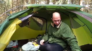 Slowly packing away the sleep system in the tent