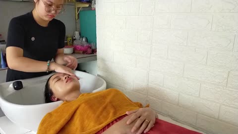 Relaxing hair wash and facial massage with a cute young girl at a Vietnamese barber shop