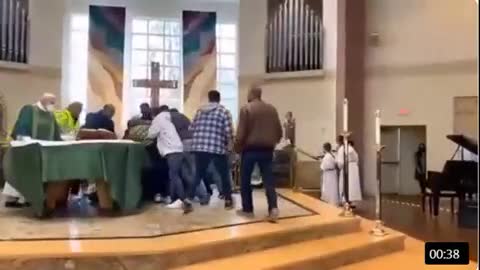 Man being dragged out of a church for not wearing a mask