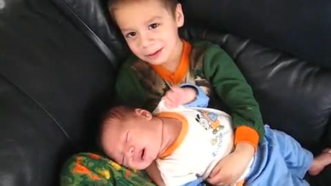 Big Brother Holds Baby Brother