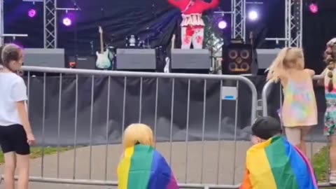 A drag queen dressed in blood throws tampons to children