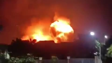 At a military base in Indonesia, a BC warehouse burns and detonates.