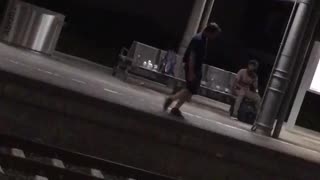 Guy black shorts shirt night time dancing subway platform