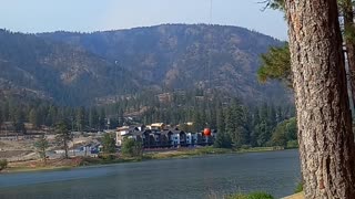 Helicopters pulling water out the lake fighting the fire in the back country