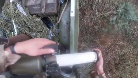 Ukrainian soldiers fire a SPG-9 anti-tank grenade launcher from the back of a pickup truck