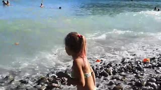 Little girl catches waves