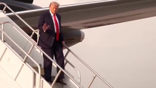 The 45th President exits Trump Force 1 and gives his supporters a thumbs up