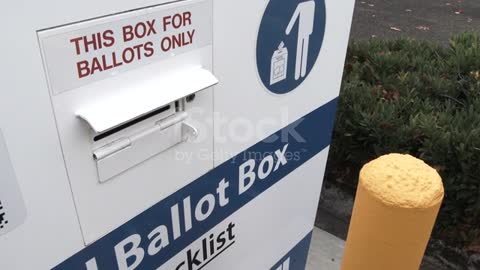 Person Delivers Ballot To Box On Election Day